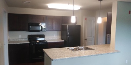 Kitchen with black appliances and breakfast bar